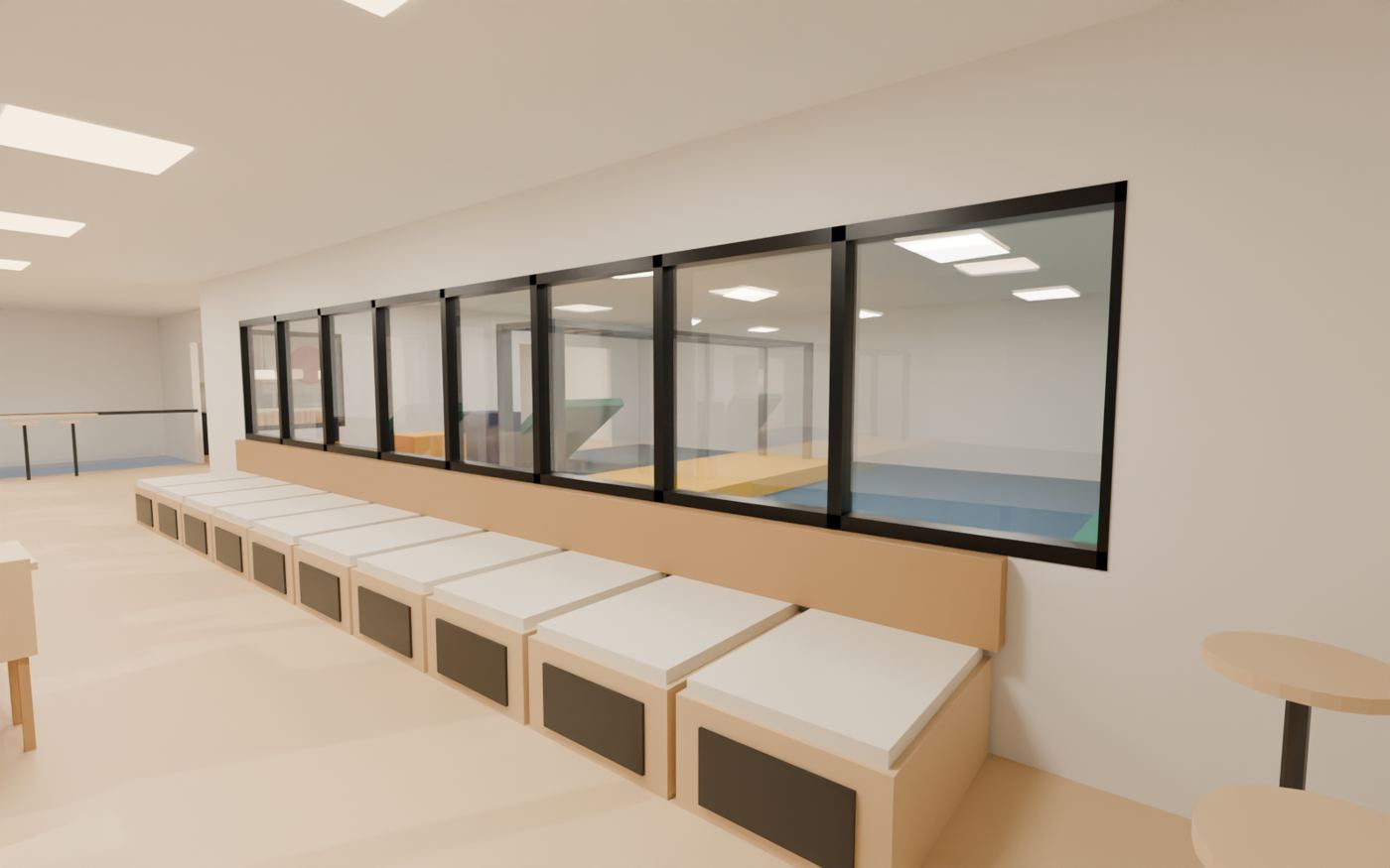 3D design model of café bench seating along a long window looking into the padded ninja play area